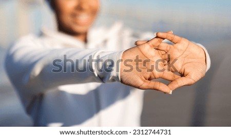 Warming Up. Smiling African American Woman Stretching Fingers Before Outdoor Fitness Training, Unrecognizable Black Female Working Out Outside, Enjoying Healthy Lifestyle, Cropped Shot