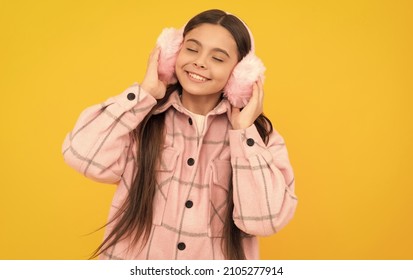 Warmth To Touch. Happy Child Enjoy Warmth Of Fur Earmuffs. Fashion Winter Accessories