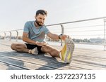 Warm-up active for running for active training, a young guy is an athlete. A man stretching his body outdoors taking care of his health.