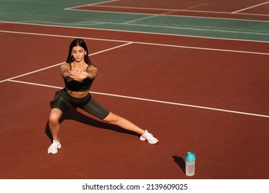 Warm-up and stretching before street workout. Attractive asian girl training on the tennis court - Shutterstock ID 2139609025