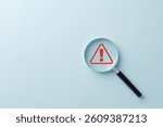 Warning Alert Symbol. A red warning symbol under magnifying glass, symbolizing risk detection, safety alerts, issue investigation, or system monitoring in business and technology contexts.