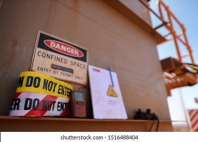 Warning Barricade Danger Tape, Caution Tape With Defocused Gas Leak Test Atmosphere Detector At Confined Space Permit At Manhole Entry Door And Permit Book Template At The Background Construction Site