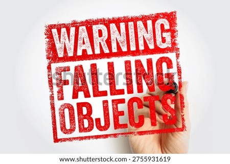 WARNING FALLING OBJECTS text on stamp. Industrial safety concept showing danger of overhead hazards at construction site or warehouse. Caution sign held by hand with marker for workplace alert