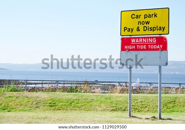 Warning high tide sign and car park pay and display\
Helensburgh uk