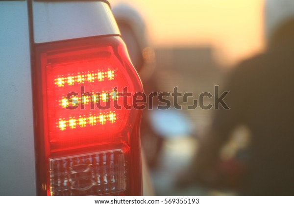 Warning light\
side back car evening, Brake lights of car back, Warning hazard\
lights car on the road traffic\
jam