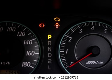 The warning lights of car engine check, parked and hand break in the speedometer of a vehicle - Shutterstock ID 2212909763