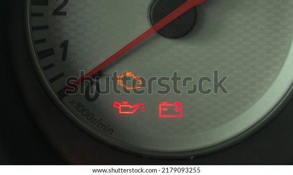 The warning lights on the car dashboard come\
on. Close-up.
