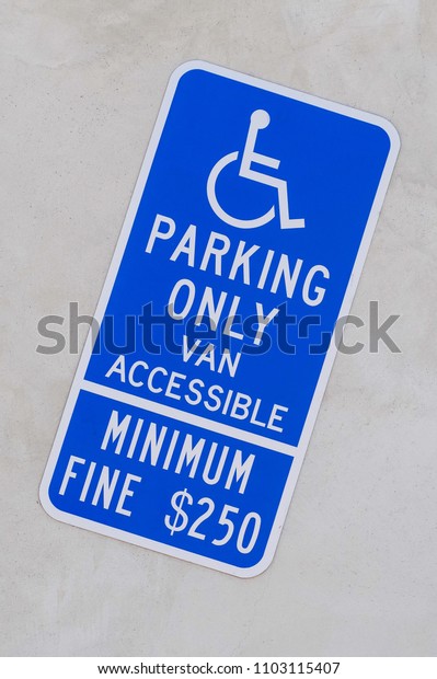 Warning parking sign for disabled\
handicapped people.  Minimum fine. Obedience on the road.\
