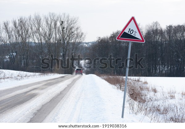 A warning road sign
and car passing by
