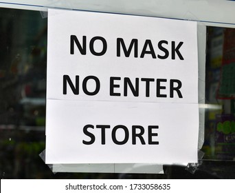 Warning Sign To Customers That A Face Mask Is Required To Enter Retail Store Due To COVID-19 Coronavirus Pandemic