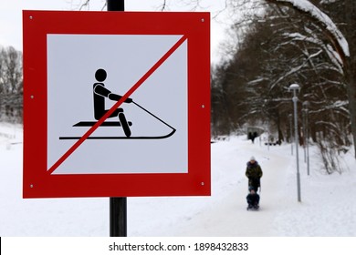 Warning Sign Forbidding Sledding In The Snowy Park. Children Safety During Winter Holidays