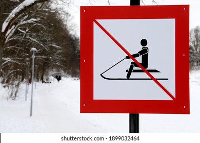 Warning Sign Forbidding Sledding In The Snowy Park. Children Safety During Winter Holidays