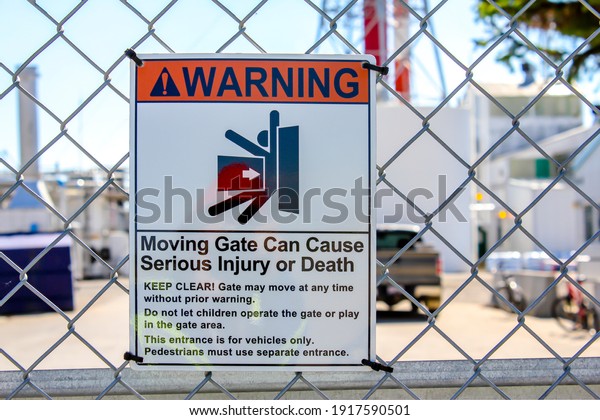 Warning Sign, Moving gate can cause\
serious injury or death message. Electric door sign.\

