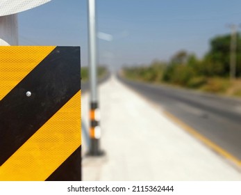 Warning Sign Of Obstacles Ahead And Blurry Road Background Should Drive Carefully