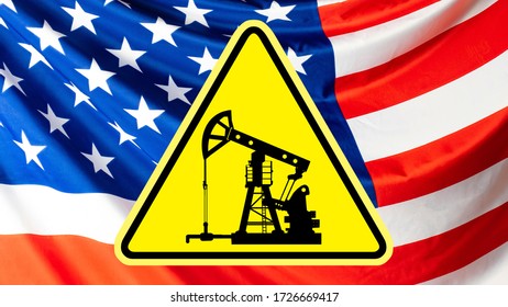 Warning Sign With An Oil Rig On The Background Of The Us Flag. Crisis Of The American Oil Industry. Warning About Difficulties In The American Oil Industry.