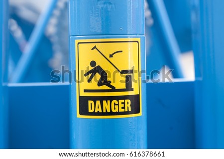 Warning sign on agricultural machinery. Before performing work under the inclined chamber and reel, it is necessary to fix the lifting cylinders with the help of the existing locking elements