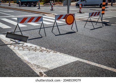 Warning Sign On A Roadblock Red And White Street Barricade On An New Asphalt Street. 