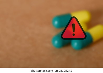 Warning Sign Over Medication Capsules – Concept of Drug Side Effects and Health Risks