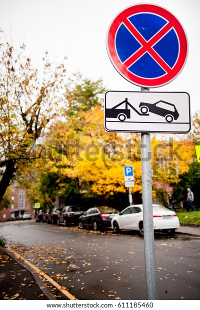 Warning\
sign for parking prohibition, autumn, wet\
asphalt
