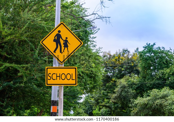Warning sign, school sign for students school\
crossing the street.