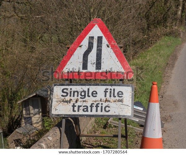 Warning Sign for Single File Traffic on the\
Edge of a Road in Rural Devon, England,\
UK