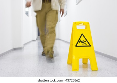 Warning Sign For Slippery Floor, Person Walking Down The Floor