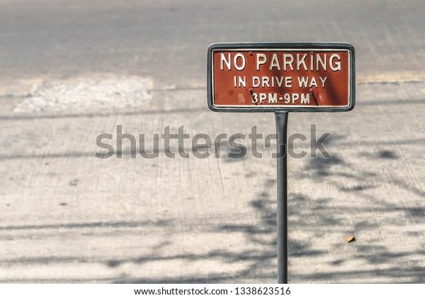 Warning sign\
stand, no parking in drive way as specified by the road which may\
have heavy traffic during that\
time.