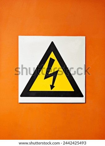 Warning, sign and voltage with triangle or symbol for alert, precaution or safety at warehouse or factory. Hazard poster or shape in beware of high wattage, electricity or power surge on mockup space