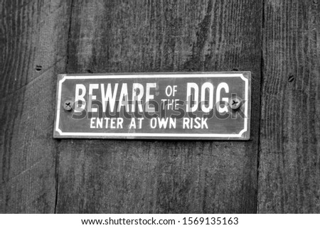 A warning sign which says beware of the dog 