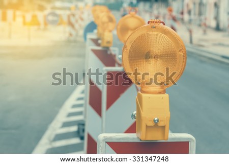 Warning signs for work in progress on road under construction. Vintage and retro style and shallow dof