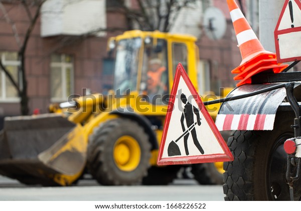 Warning street sign on\
road work site.