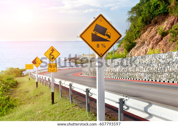 warning symbol sign for traffic protecion in\
the mountain road photo in sun\
lighting.