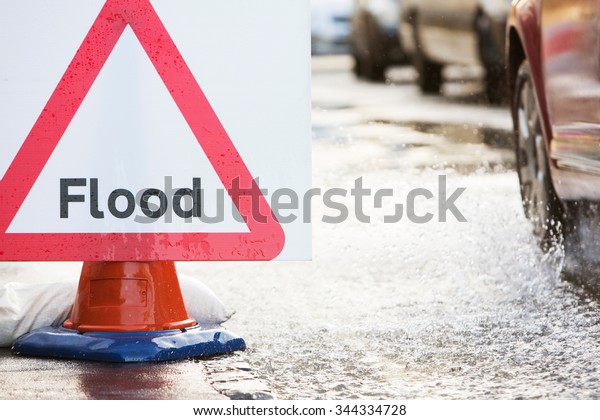 Warning Traffic\
Sign On Flooded Road With\
Cars