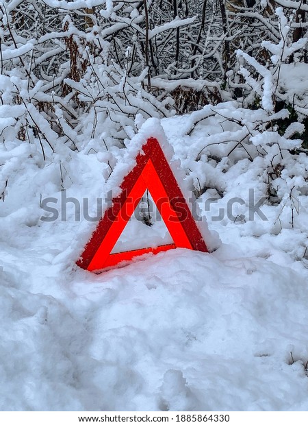 Warning triangle, car breakdown in winter on a\
snowy road in Sweden