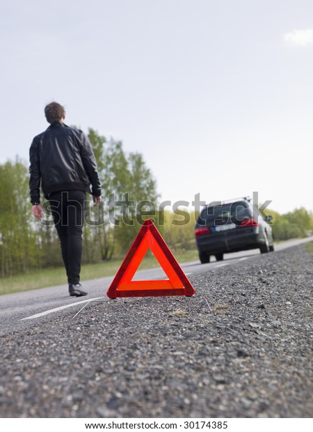 Warning triangle in\
front of a car\
breakdown