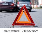 Warning Triangle Placed on Road After Vehicle Accident in Urban Area During Daylight