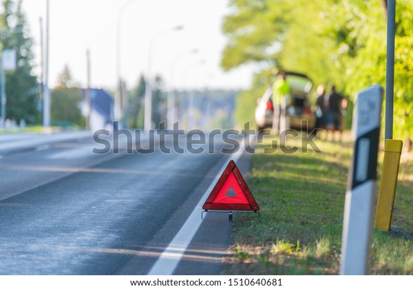 Warning triangle was set up at a safe distance\
behind the car with the\
breakdown