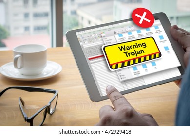 Warning Trojan Concept Computing Computer  Laptop with screen on table Silhouette and filter sun