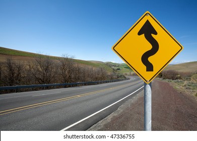 warning winding traffic sign winding road on background