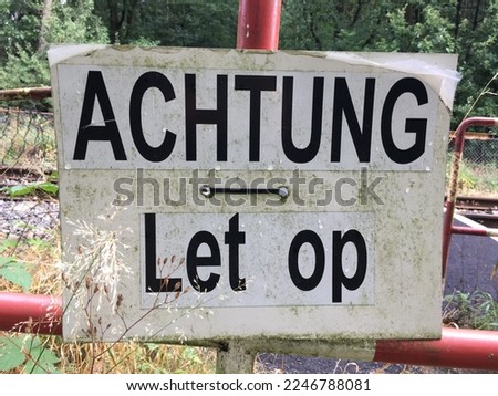 Warningsign at a railroadcrossing at the border between Netherlands and Germany