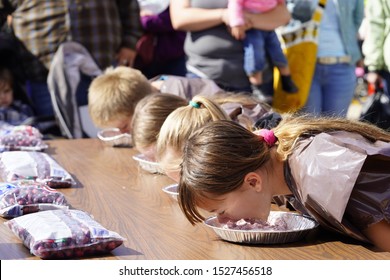 Warren, Wisconsin / USA - September 28th, 2019: Young competitors compete in pie eating contest at Warrens, Wisconsin Cranberry festival  
