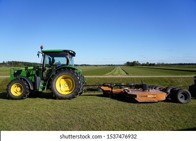 Warrens, Wisconsin / USA - September 28th, 2019: John Deere Tractor Farming Equipment Being Used On Cranberry Fields To Harvest Cranberries.   