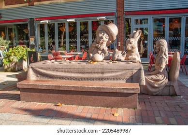 Warrington, UK - October 27, 2019 - 'Tea Party' Sculpture Depicting Four Lewis Carroll Characters - Alice, The Mad Hatter, The Sleepy Dormouse And The March Hare In Golden Square, Warrington, Cheshire