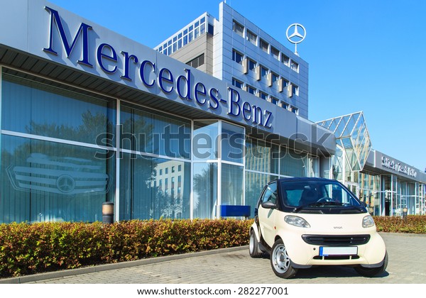 WARSAW- APRIL 1: A Smart car next to Mercedes Benz\
Centre in Warsaw on April 1, 2015. Smart is the most popular small\
car in Europe