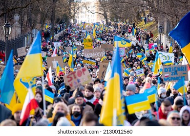 Warsaw, February 26, 2022: Protest against war in Ukraine and Russia's invasion. People marching with flags at demonstration in support of Ukraine
