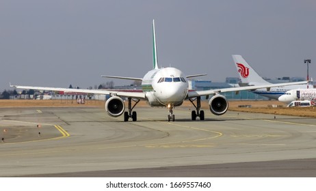 Warsaw, Frederic Chopin Warszawa Intl Airport (EPWA) / Poland - 30.03.2018: Airbus A320 Alitalia Taxi And Line-up Procedure. Air China Aircraft Stay At The Terminal.