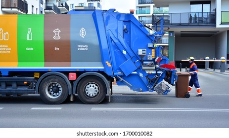 Warsaw, Poland. 10 April 2020. A Public Utility Worker Collects Garbage From Garbage Cans In A Garbage Truck. 