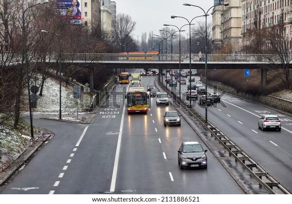 Warsaw, Poland, 2022. Trasa Lazienkowska, aleja\
Lecha Kaczynskiego in Warsaw, during winter. View on cars and buses\
covered by snow. Aerial view. Small traffic. Public buses. Covid\
time. Bus lane.