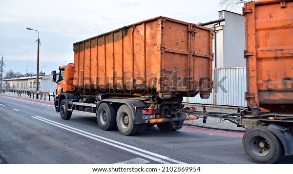 Warsaw, Poland. 8 January\
2022. Truck for the removal of large-sized garbage. Municipal\
economy. The trash bin is mounted on the truck. Removal of\
construction debris.
