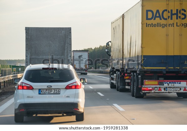 Warsaw, Poland - April\
11, 2021: Road transport by trucks. Traffic on the express road.\
Overtaking trucks.